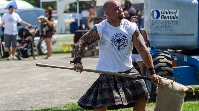 A man competes in the highland games.