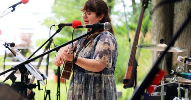 A musician plays guitar and sings a song.