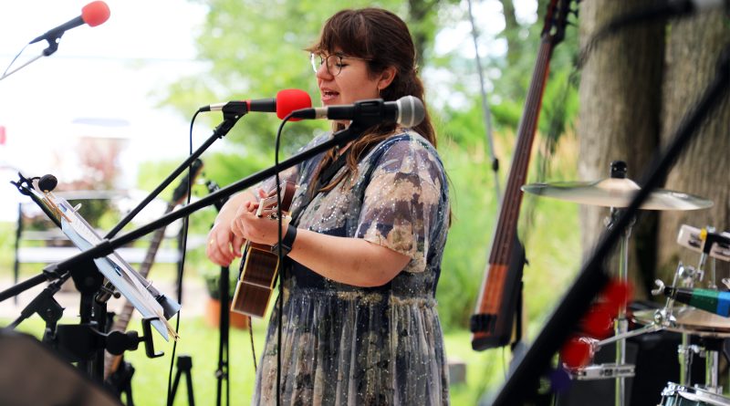 A musician plays guitar and sings a song.