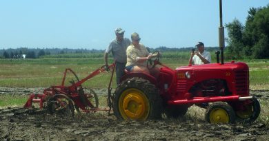 A tractor plows a row.