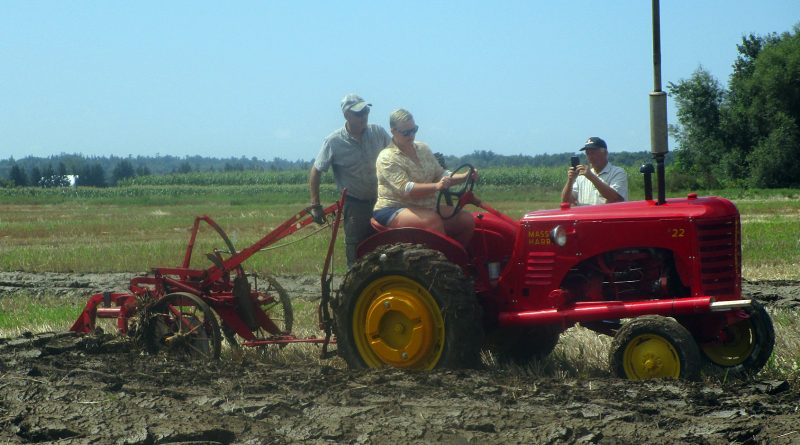 A tractor plows a row.