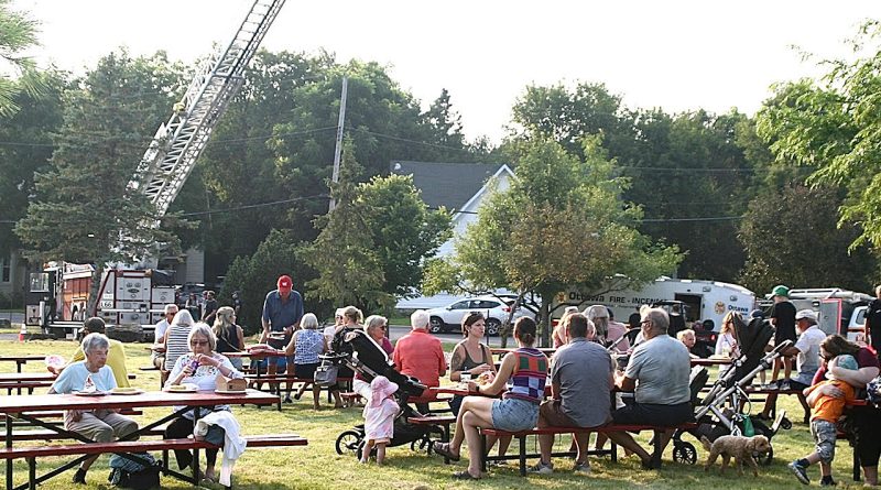 A photo of a picnic at a fire hall.