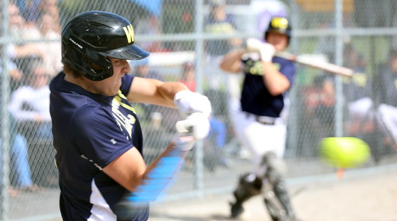 A batter swing at a pitch.