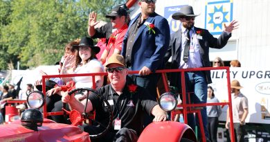 A photo of a bunch of people on a tractor hay wagon.