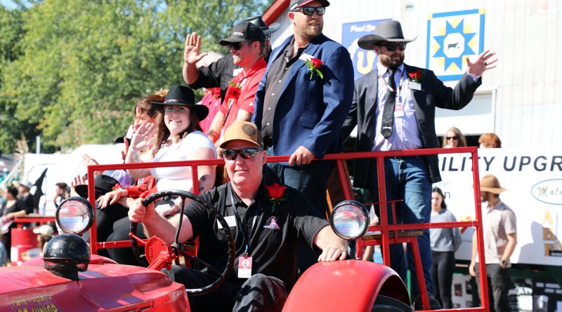 A photo of a bunch of people on a tractor hay wagon.