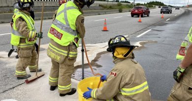 Firefighters clean up a spill.