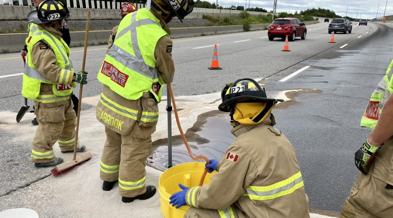 Firefighters clean up a spill.