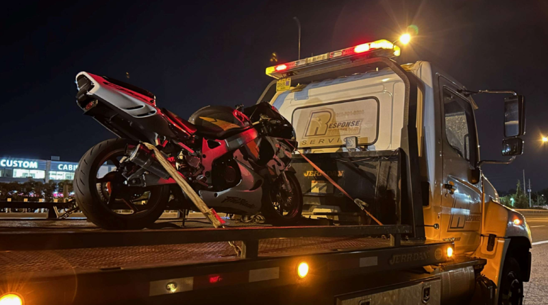 A photo of a bike on a tow truck.