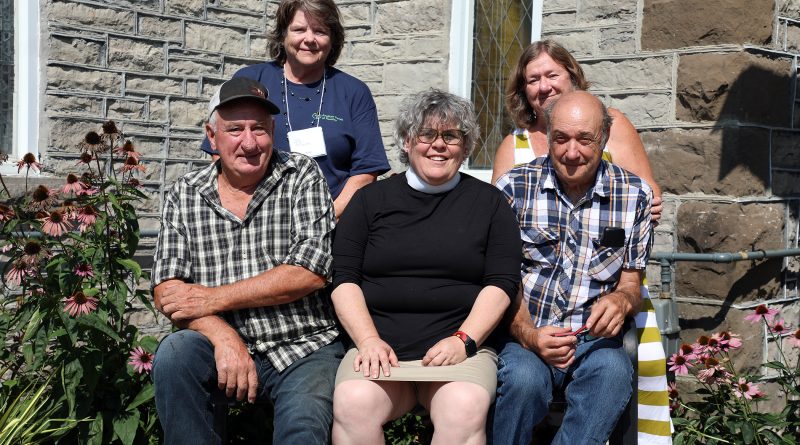 A group poses in front of a church.