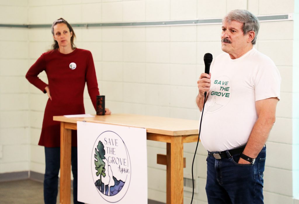 Two people talk at a podium.