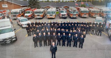 A photo of a whole bunch of firefighters and their equipment.