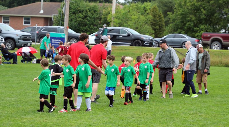 Teams shake hands after a soccer club.