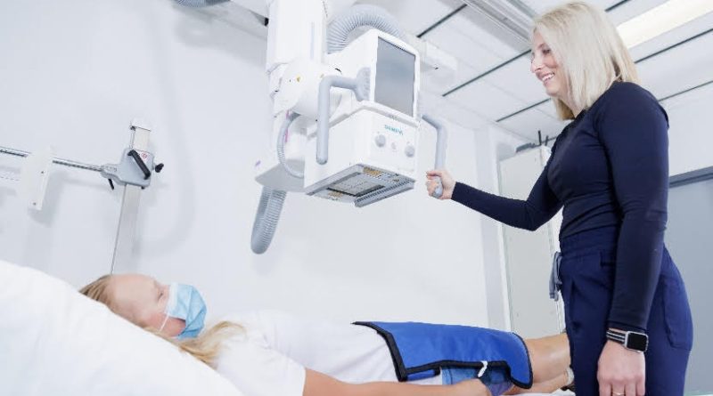 A technician does some imaging of a patient.