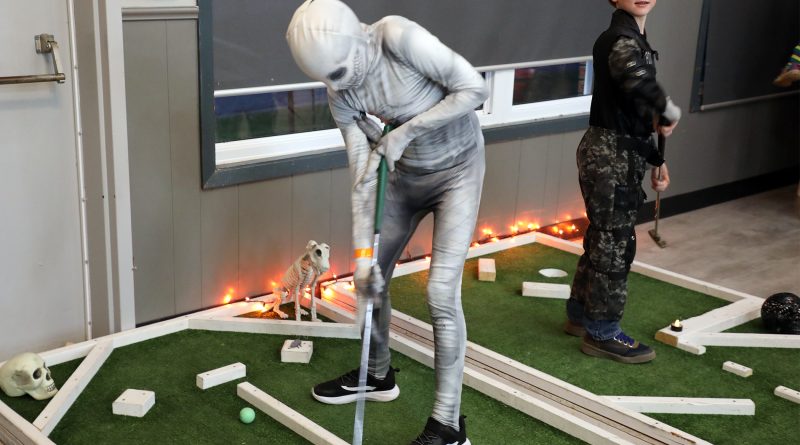 A photo of a ghoul playing mini-putt.