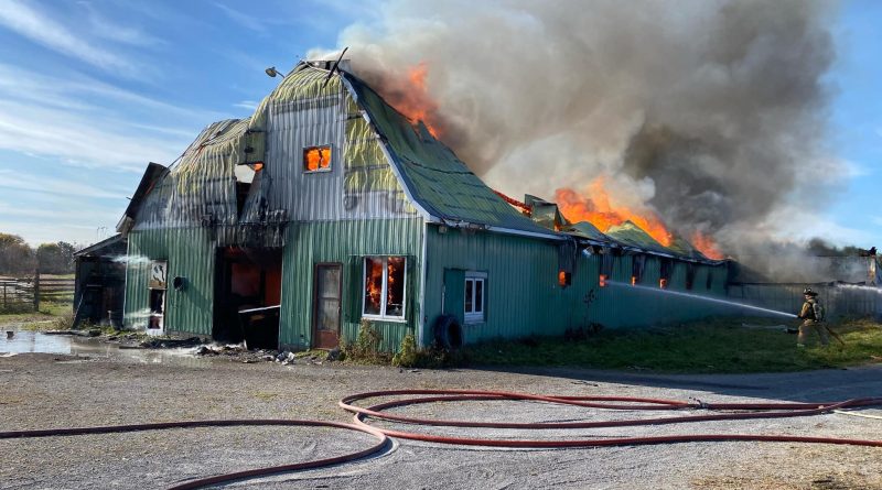 Firefighter battle a raging barn fire.