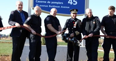 Firefighters cut a hose with heavy duty metal cutters.