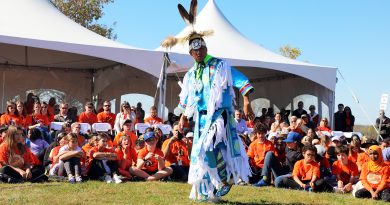 A man dances in front of others.