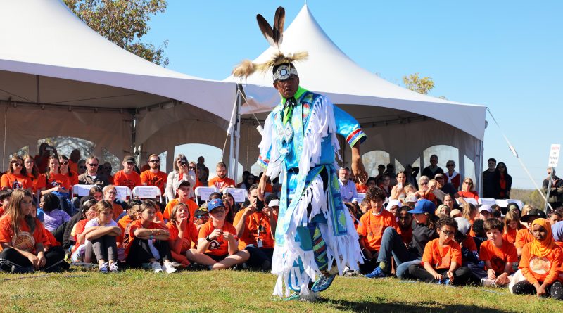 A man dances in front of others.