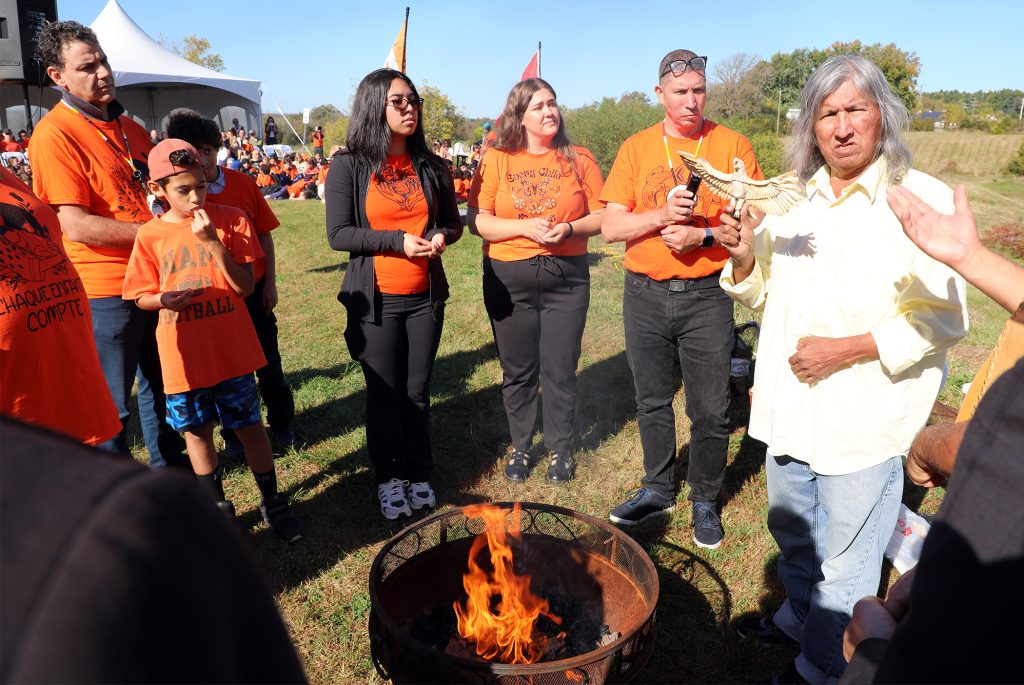 People gather around a fire.