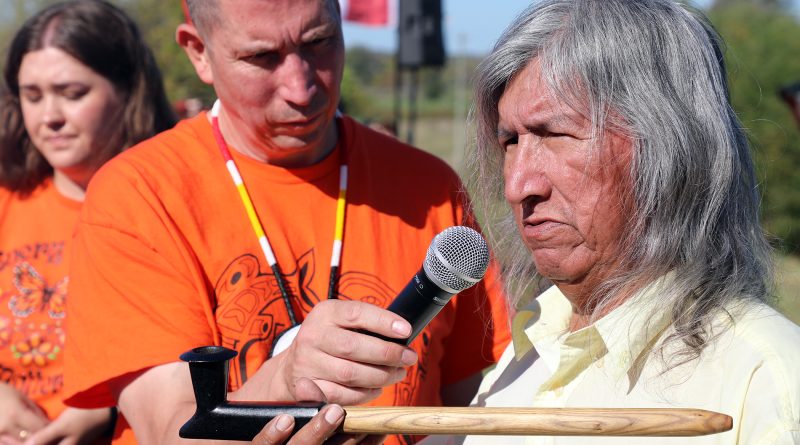 A man holds a pipe.