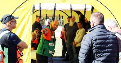 A man speaks in a large tent.