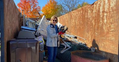 A person stands in a garbage bin.