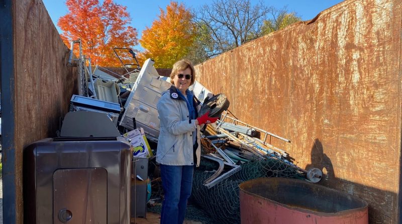 A person stands in a garbage bin.