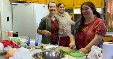 Volunteers pose in a kitchen.