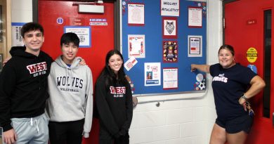 Four people pose for a photo.