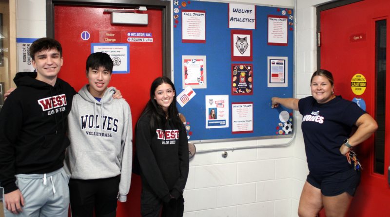 Four people pose for a photo.