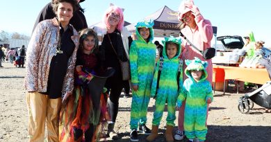 A group of costumed people pose for a photo.