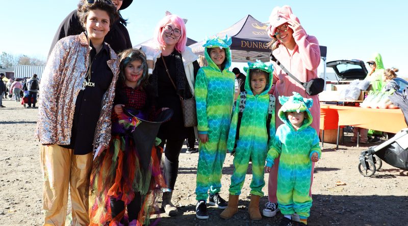 A group of costumed people pose for a photo.