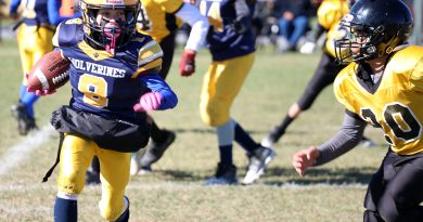 A football player runs down field.