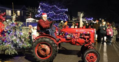 Santa drives a tractor.