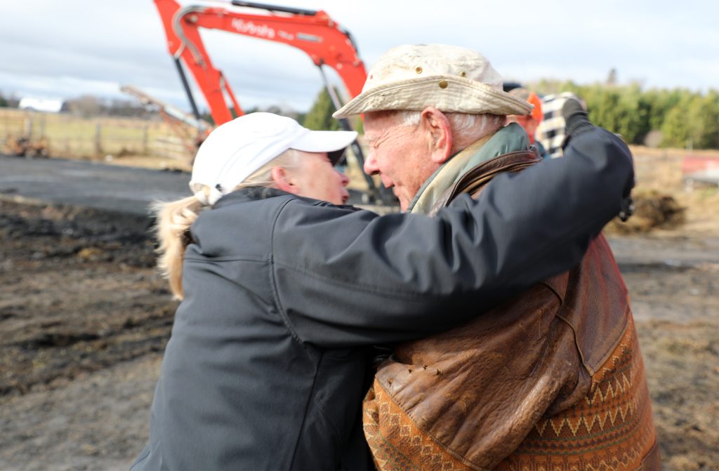 Two people hug.