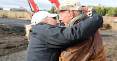 Two people hug.