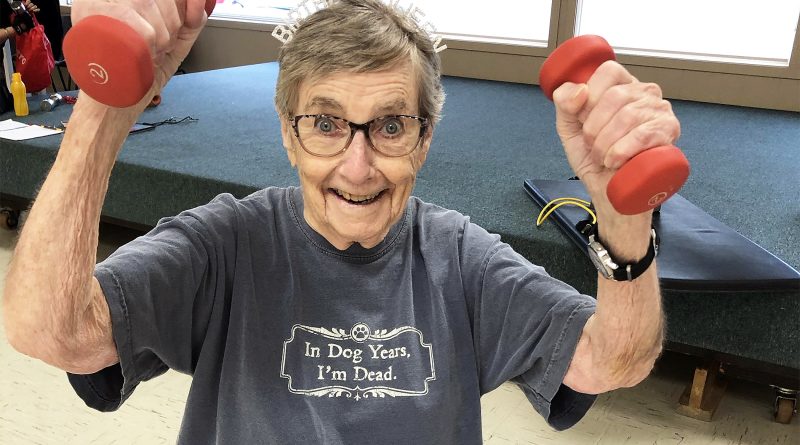 A woman lifts weights.