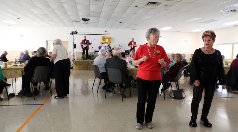 Two people dance in a hall.