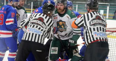 Referees hold back an Arnprior hockey player.