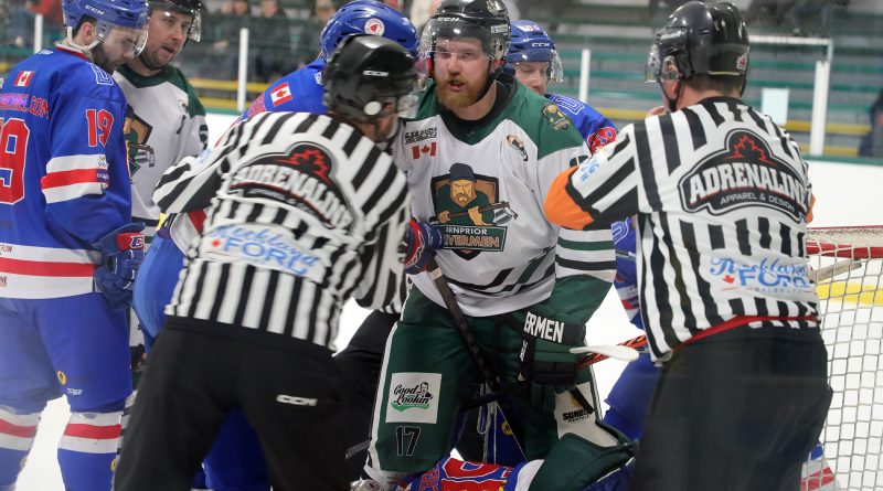 Referees hold back an Arnprior hockey player.