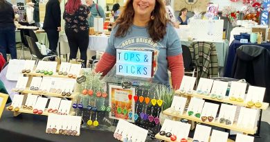 A vendor poses with her wares.