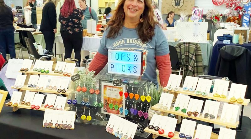 A vendor poses with her wares.