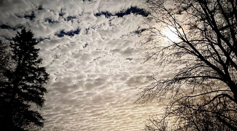 A photo of the moon in the clouds.