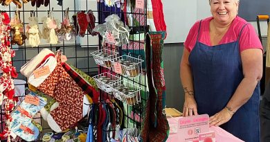 A woman poses with her products.