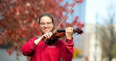 A photo of a woman playing a violin