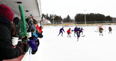 People play hockey outdoors.