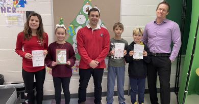 A photo of people holding Christmas cards.