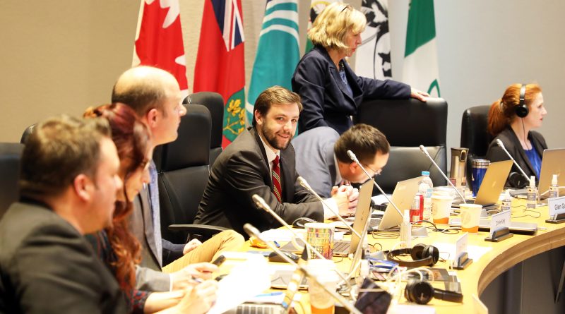 A photo of a councillor at the council table.