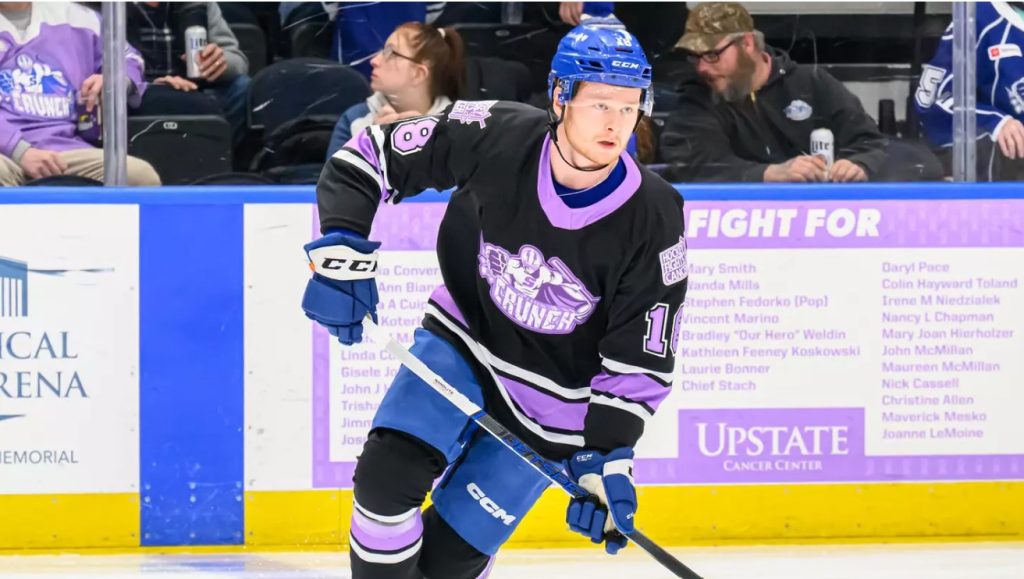 A hockey player skates on the ice.