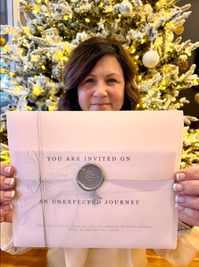 A woman poses with a large envelope.